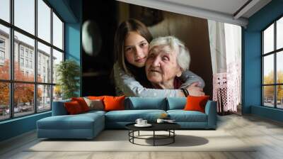 Portrait of an elderly woman with her young granddaughter. Wall mural