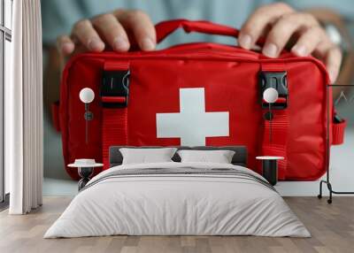 A red first aid kit with a white cross, designed for medical emergencies. Wall mural