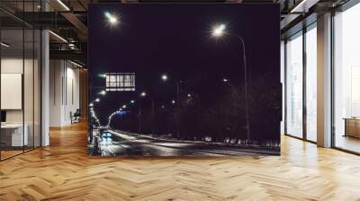 Night almost empty track with a lonely car in the light of lanterns Wall mural