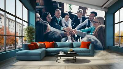 Above high angle view of nice stylish cheerful positive corporate culture company managers putting palms enjoy teambuilding care at modern industrial loft interior work place open space Wall mural