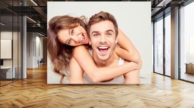 Cheerful smiling couple in love hugging in the bedroom Wall mural