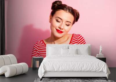 Close up photo beautiful amazing she her lady pretty hairdo two buns red pomade lips hold hands arms on heart eyes closed overjoyed wear casual striped red white t-shirt isolated pink background Wall mural