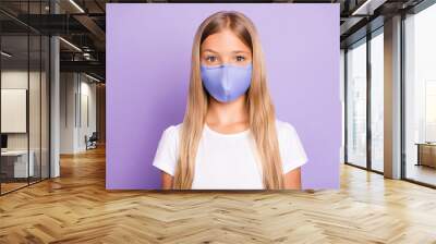 Close up photo of pretty positive cheerful child look have covid-19 quarantine her family friends wear white breathing mask t-shirt clothes isolated over violet color background Wall mural