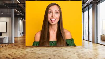 Close-up portrait of attractive cheerful funky brown-haired girl fooling grimacing isolated over bright yellow color background Wall mural