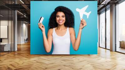 Close-up portrait of her she nice attractive cheerful wavy-haired girl holding in hands plane paper form credit card loan new life rout isolated on bright vivid shine vibrant blue color background Wall mural