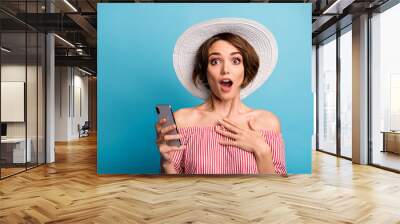 Close-up portrait of her she nice attractive lovely pretty cheerful cheery amazed brown-haired girl using cell good news isolated on bright vivid shine vibrant blue color background Wall mural