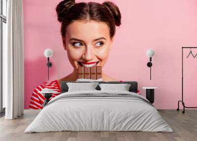 Close-up portrait of her she nice cute charming attractive glamorous cheerful sly cunning hungry girl in striped t-shirt biting tasting eating desirable favorite dessert isolated on pink background Wall mural