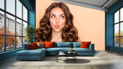 Close-up portrait of her she nice-looking attractive sweet gorgeous girlish curious wavy-haired girl looking aside sending kiss pout lips copy space isolated over beige pastel color background Wall mural