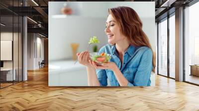 Close-up portrait of her she nice-looking sweet lovely charming cute attractive cheerful cheery positive brown-haired lady tasting new salad mix farm vegs in light white interior style kitchen Wall mural