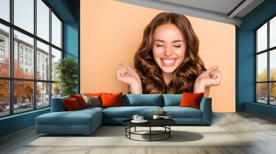 Close-up portrait of nice attractive lovely gorgeous girlish excited cheerful cheery dreamy lucky wavy-haired girl enjoying expecting pleasure isolated on beige pastel color background Wall mural