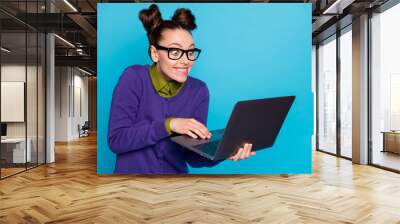 Close-up portrait of nice attractive smart clever comic childish cheery foxy girl holding in hands laptop writing e-mail isolated bright vivid shine vibrant blue green teal turquoise color background Wall mural