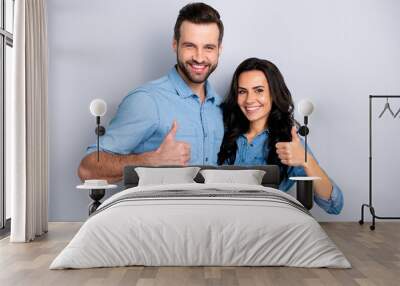 Close up portrait two beautiful amazing she her he him his couple lady guy stand close hold hands thumbs up recommend news wear casual jeans denim shirts outfit clothes isolated light grey background Wall mural