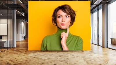 Closeup photo of amazing short hairdo lady looking up empty space deep thinking creative person arm on chin wear casual green turtleneck isolated yellow color background Wall mural