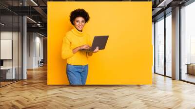 Copyspace photo of attractive intelligent cheerful business black stylish beautiful woman holding lap top with hands browsing through wearing yellow pullover isolated vivid color background Wall mural