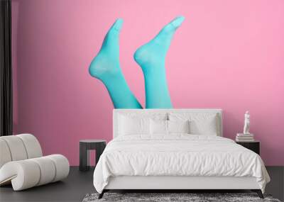 Cropped close-up view of nice feminine legs wearing blue soft cotton bright cosy comfy socks hosiery isolated over pink pastel color background Wall mural