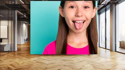 Cropped photo of happy cheerful small lady stick out tongue good mood empty space isolated on teal color background Wall mural