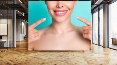 Cropped photo of young cheerful smiling woman wear no clothes point finger at new teeth isolated on turquoise color background Wall mural