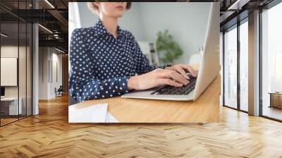 Cropped view portrait of attractive serious focused skilled girl specialist typing writing text data at work place station indoors Wall mural