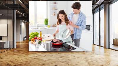 Dear when meal ready. Dream harmony two people couple girl frying pan raw fresh meat hold spatula man touch her shoulders enjoy cooking hobby weekend in kitchen house indoors Wall mural