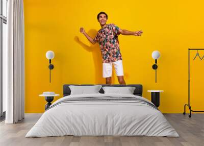 Full body length size photo of funky young man in t shirt with white shorts discotheque summertime isolated on yellow color background Wall mural