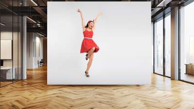 Full body photo of attractive woman dance raise hands enjoy holiday dressed red vintage style polka dot skirt isolated on white background Wall mural