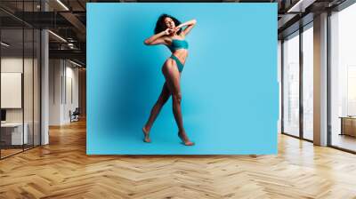 Full body photo of attractive young woman posing model graceful dressed cyan lingerie no filter isolated on blue color background Wall mural