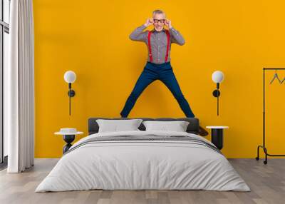 Full body photo of energetic laughing confident businessman in spectacles isolated on yellow color background Wall mural