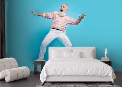 Full body photo of handsome excited aged man happy positive smile dance discotheque isolated over blue color background Wall mural