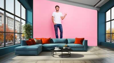 Full body photo of positive cheerful middle eastern man point index finger copyspace show ads promo discounts wear trend modern imposing outfit isolated over pastel color background Wall mural