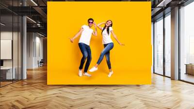 Full body photo of two people dancing at first season theme party wear cool specs and casual clothes isolated yellow color background Wall mural