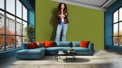 Full body portrait of nice young girl folded arms look empty space isolated on khaki color background Wall mural