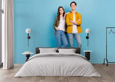 Full body size cadre of girlfriend with boyfriend wear stylish clothes folded hands man zara collection brand isolated on blue color background Wall mural