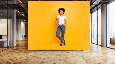 Full length body size photo beautiful amazing she her dark skin lady lovely look self-confident optimistic nice cool wear casual white t-shirt isolated yellow bright vibrant vivid background Wall mural