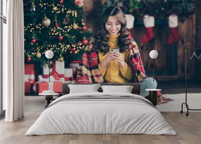 Full length body size photo of cheerful cute nice attractive girlfriend browsing through her telephone while sitting at home wearing yellow jumper Wall mural