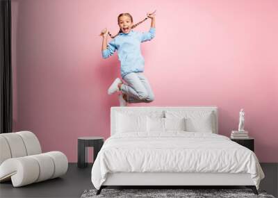 Full length body size photo of cheerful positive ecstatic overjoyed rejoicing girl jumping up wearing jeans denim blue sweatshirt sweater isolated over pastel color background Wall mural