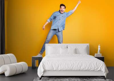 Full length body size photo of cheerful screaming positive man in white footwear flying away with umbrella by wind blowing isolated vivid color background Wall mural