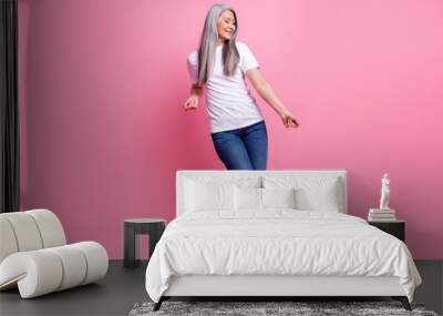 Full length body size photo of woman dancing spending free time at party isolated pastel pink color background Wall mural