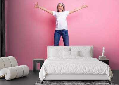 Full length body size photo of woman jumping up careless happy isolated pastel pink color background Wall mural