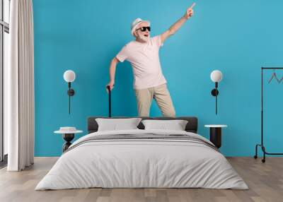 Full length body size photo senior man wearing casual outfit pointing finger copyspace isolated bright blue color background Wall mural