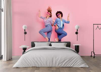 Full length body size profile side view portrait of two person nice carefree attractive playful cheery girls in casual checkered shirt having fun rejoice isolated over pink pastel background Wall mural