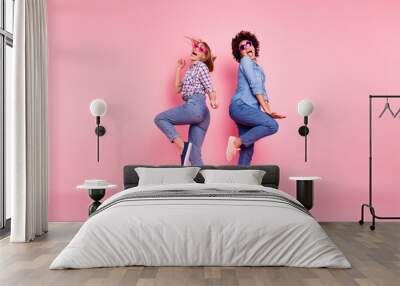 Full length body size profile side view portrait of two person nice crazy carefree attractive charming playful cheery girls in casual checkered shirt having fun isolated over pink pastel background Wall mural