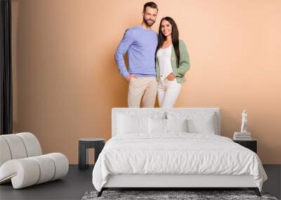 Full length body size view of attractive cheerful couple soulmates embracing isolated over beige pastel color background Wall mural