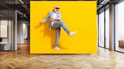 Full length body size view of attractive cheerful crazy grey-haired man dancing having fun isolated over bright yellow color background Wall mural