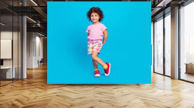 Full length body size view of attractive cheerful shy girl posing isolated over vibrant blue color background Wall mural