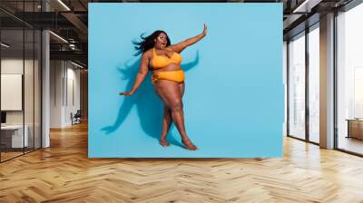 Full length body size view of attractive cheery funny woman dancing posing having fun isolated over bright blue color background Wall mural