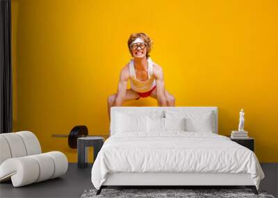 Full length body size view of his he nice funky slim motivated desperate foxy guy lifting barbell doing work out coacher program isolated over bright vivid shine vibrant yellow color background Wall mural