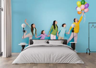 Full length body size view of nice attractive lovely dreamy cheerful big full adopted family having fun holding flying air balls decoration isolated on bright vivid shine vibrant blue color background Wall mural