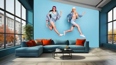 Full length body size view of nice-looking attractive lovely slim fit cheerful cheery glad girls running fast action motion isolated over bright vivid shine blue green turquoise background Wall mural