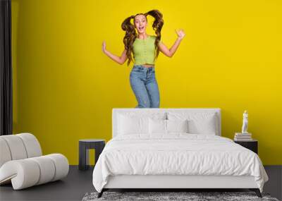 Full length body size view of pretty cheerful girl jumping fooling having fun isolated over bright yellow color background Wall mural