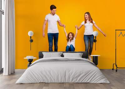 Full length body size view of three nice attractive lovely stylish cheerful cheery careless playful person mommy daddy having fun isolated over bright vivid shine yellow background Wall mural